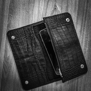 May include: Black leather wallet with a crocodile skin texture, open to reveal a smartphone inside. The wallet has a zipper closure and snap closures. The date 2022/9/12 08:52 is visible in the bottom right corner.