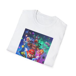 Folded white gamer t shirt showing part of the Super Mario Galaxy inspired design. The folded presentation highlights the upper section of the colorful cosmic artwork including stars galaxy elements and playful platform game character details. The image emphasizes the soft cotton texture of the Gildan 64000 shirt and the vibrant high quality print used for the retro gaming design.