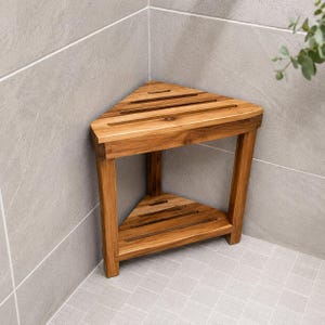 May include: A wooden corner shower bench with a triangular design. The bench is made of light brown wood and features a slatted top and a lower shelf. It is placed in a corner of a tiled shower.