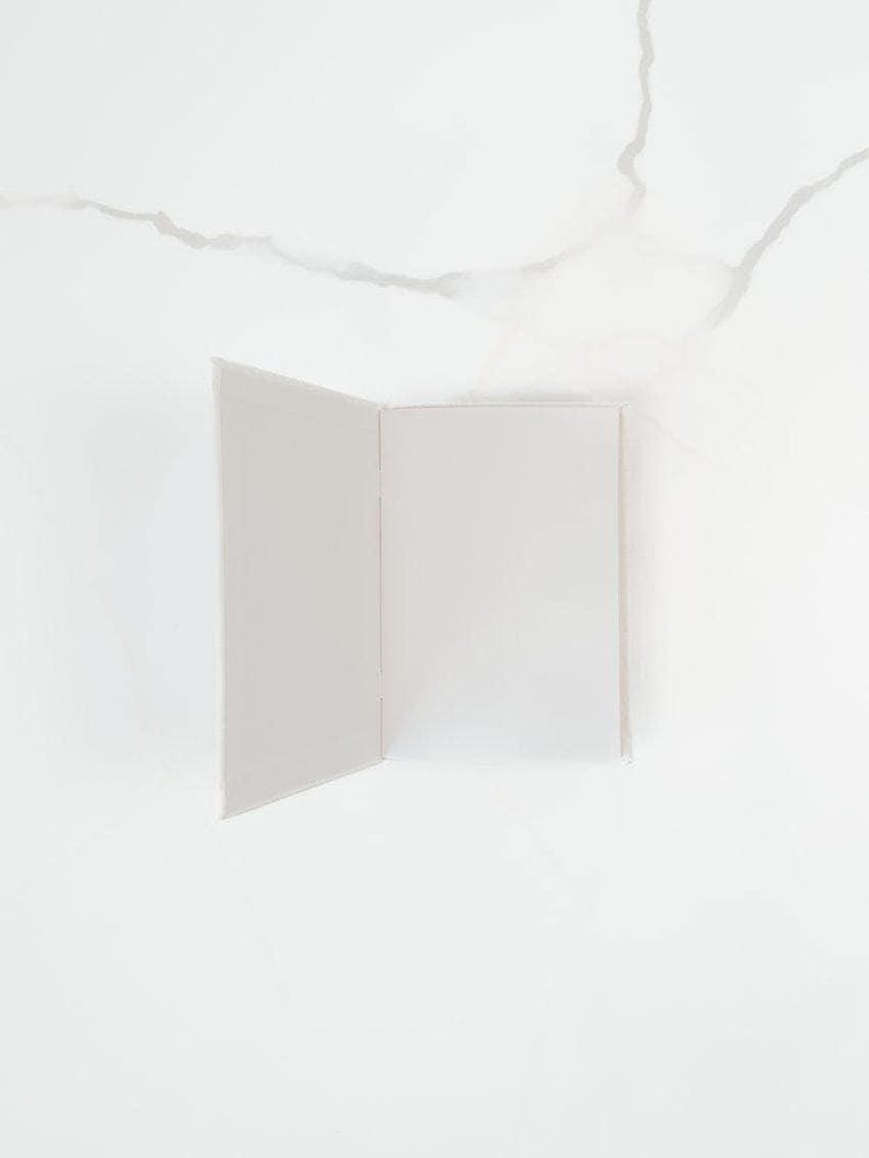 an open book with blank pages against a white background.