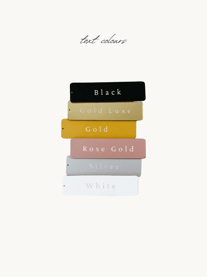 A stack of six rectangular tags, each with a different color, representing the text colors: Black, Gold Luxe, Gold, Rose Gold, Silver, and White.
