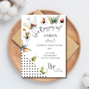 May include: A white invitation with black polka dots and colorful cartoon bugs. The text reads "We're Bugging Out, Jamison is turning 5, Saturday August 24, 2024, 3PM, City Park, 123 Park Drive, Any City, State 12345, RSVP, Kate, 123-456-7800".