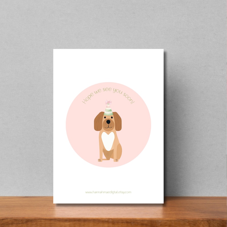 May include: A pink and white card with a brown dog wearing a green and white party hat. The text on the card says "Hope we see you soon!" and includes a website address.