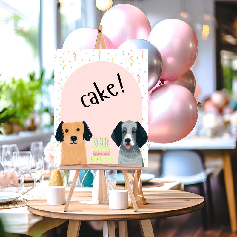 May include: A pink and white sign with the words "cake!" on it. Two cartoon dogs are on either side of the text. The sign is on a wooden easel. There are pink and white balloons in the background.