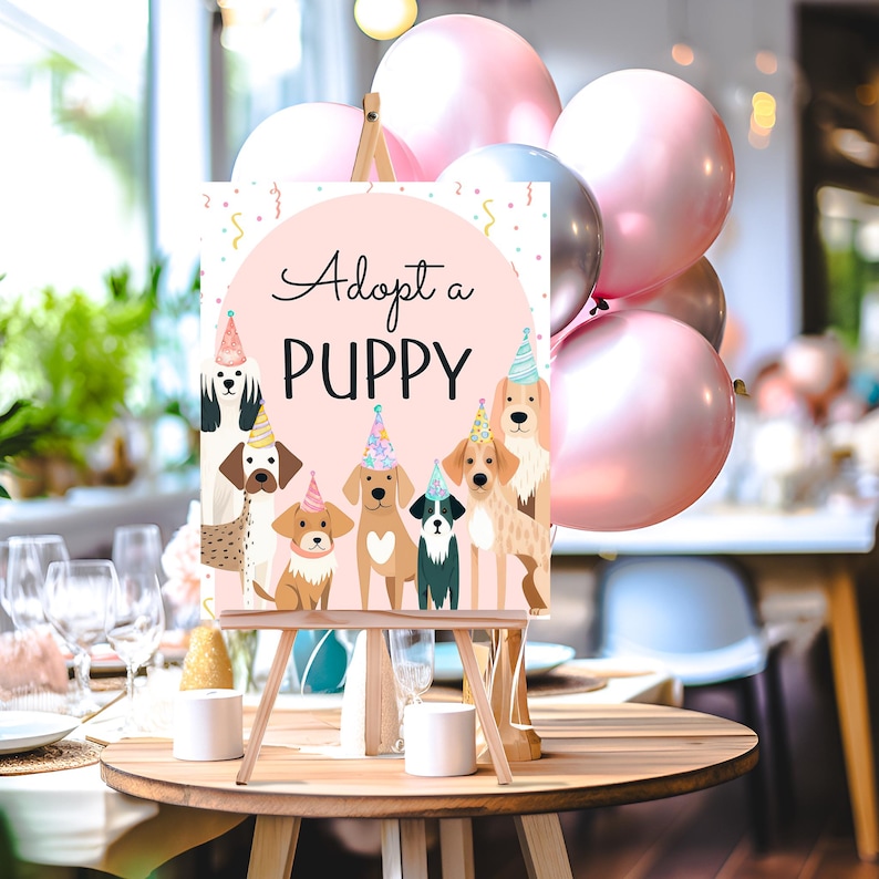 May include: A pink and white sign with the text "Adopt a Puppy" and illustrations of seven puppies wearing party hats. The sign is on a wooden easel.