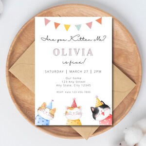 May include: A birthday party invitation with a colorful banner and three cartoon cats wearing party hats. The text reads "Are you Kitten Me? Olivia is five! Saturday | March 27 | 2PM Our home 123 Any Street Any State, City 12345 RSVP: Kate 123-456-7890"