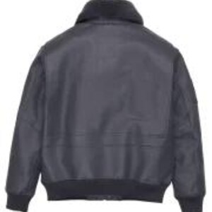 May include: A dark grey bomber jacket with a black faux fur collar and ribbed hem and cuffs. The jacket features a zip closure and two front pockets. The jacket is made of a durable, water-resistant material.