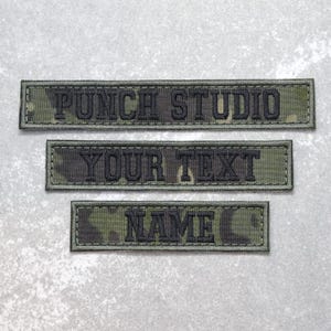 May include: Three rectangular embroidered patches featuring a green, brown, and black camouflage pattern. The top patch reads PUNCH STUDIO, the middle patch reads YOUR TEXT, and the bottom patch reads NAME in black block lettering.