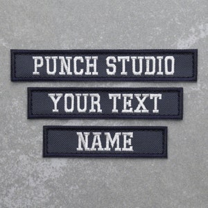 May include: Three navy blue fabric patches with white embroidered text. The top patch reads "Punch Studio", the middle patch reads "Your Text", and the bottom patch reads "Name".