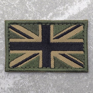 May include: An embroidered patch featuring the Union Jack flag in green, black and tan.