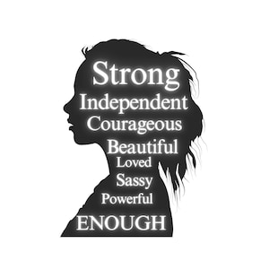 May include: Black silhouette of a woman's head with the words "Strong, Independent, Courageous, Beautiful, Loved, Sassy, Powerful, ENOUGH" written in white inside the silhouette.