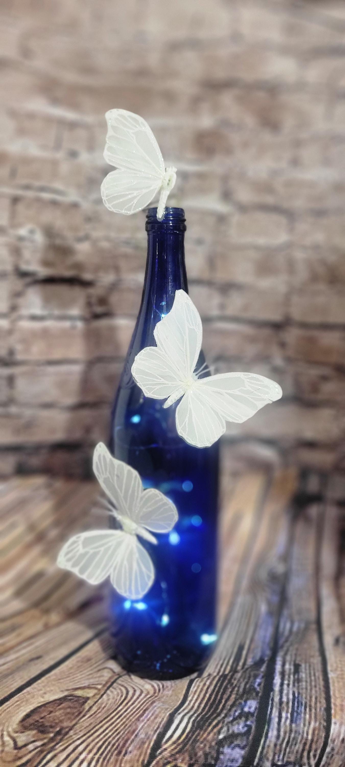 Cobalt blue wine bottle electric LED lights with white butterflies table decor centerpiece - Thumbnail 2