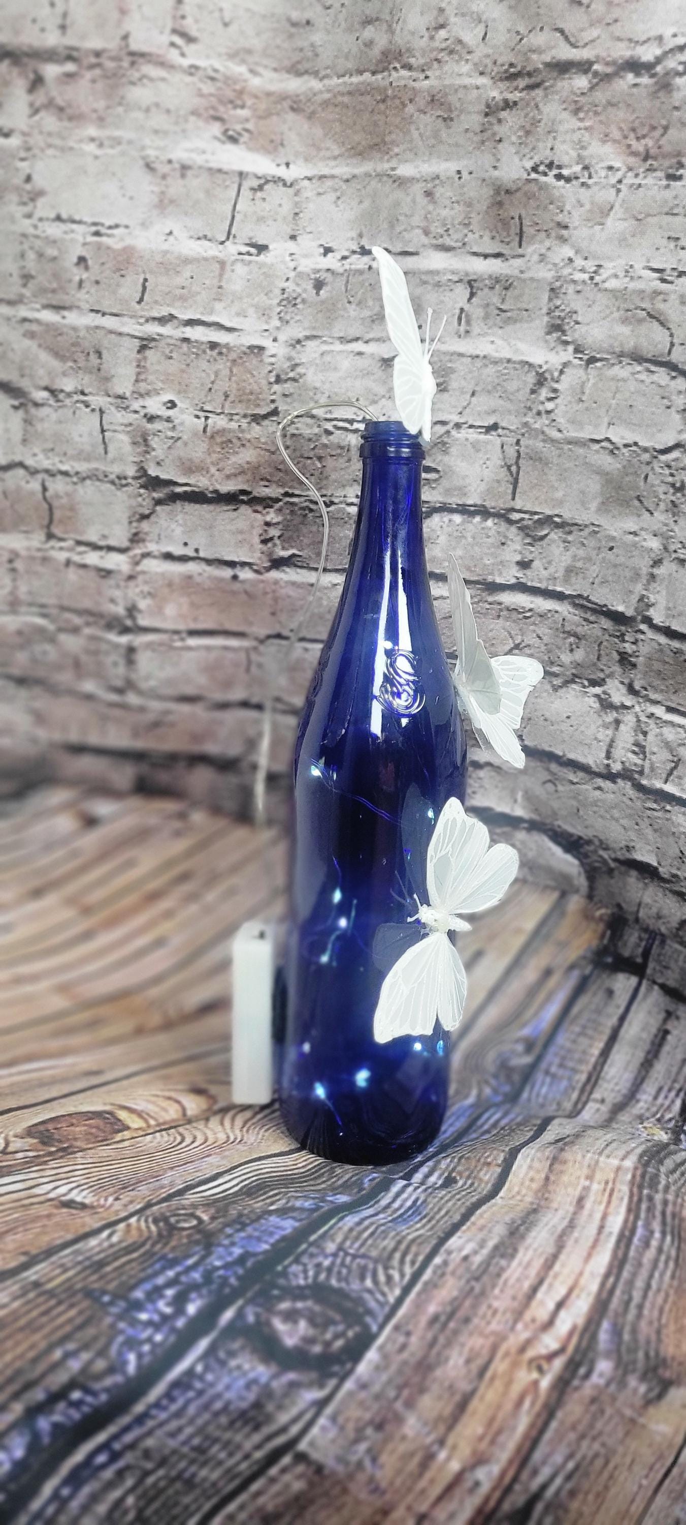 Cobalt blue wine bottle electric LED lights with white butterflies table decor centerpiece - Thumbnail 7