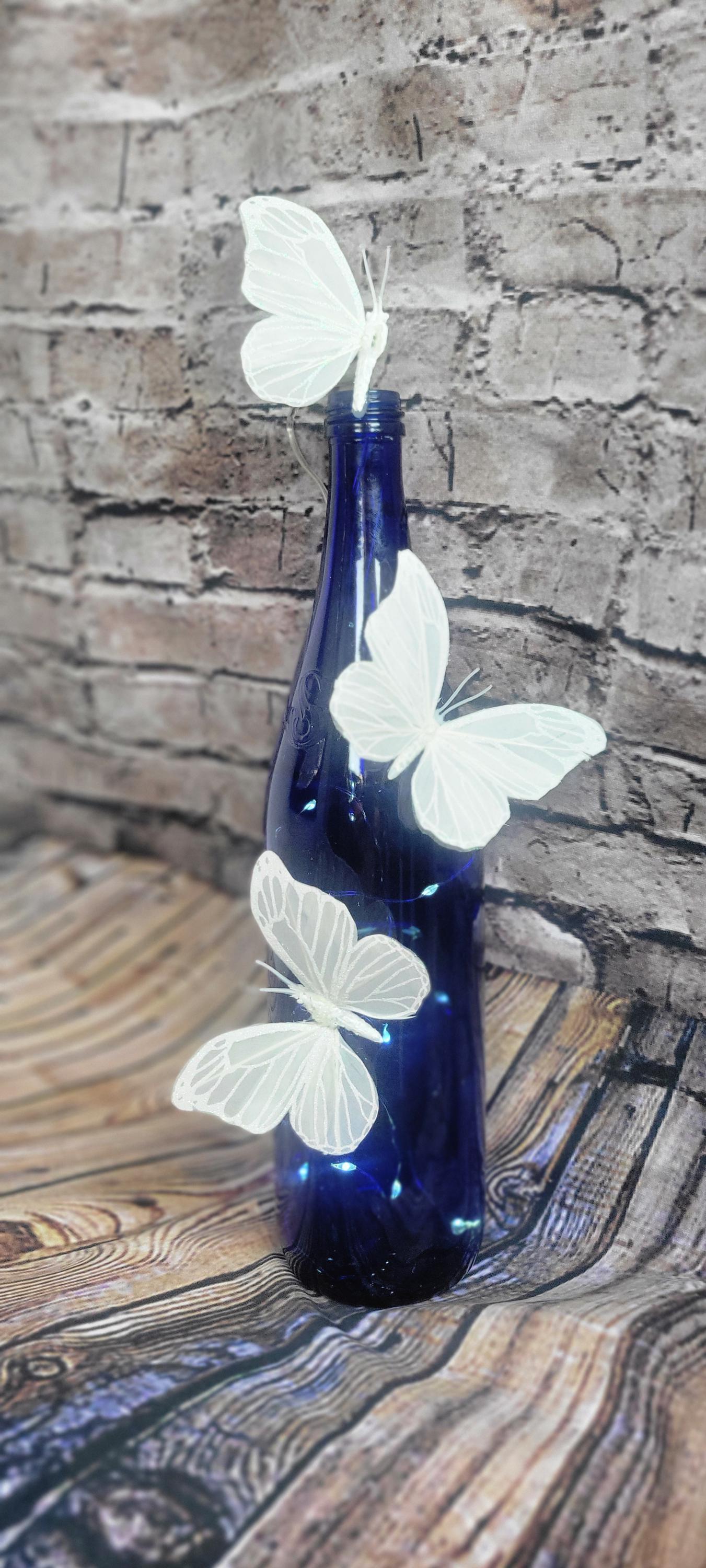 Cobalt blue wine bottle electric LED lights with white butterflies table decor centerpiece - Thumbnail 6
