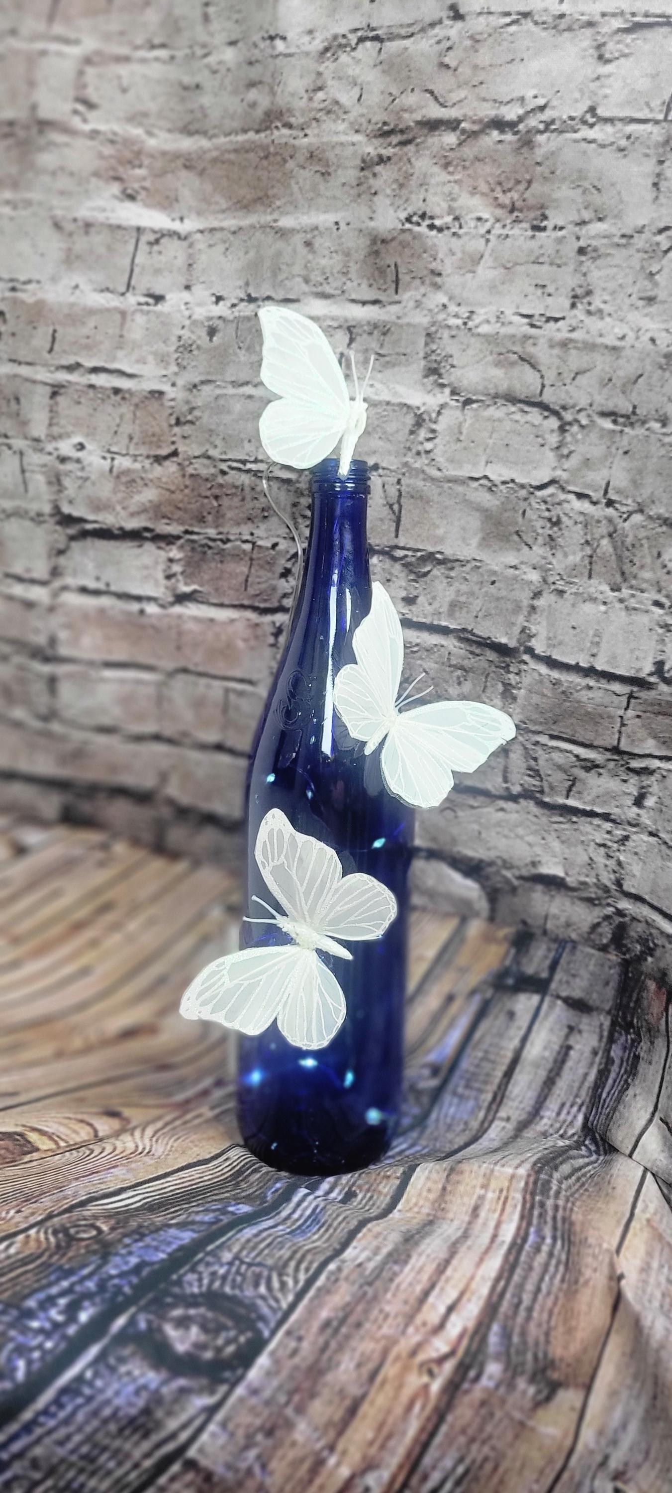 Cobalt blue wine bottle electric LED lights with white butterflies table decor centerpiece - Thumbnail 5