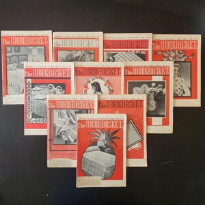 May include: A collection of ten vintage The Workbasket magazines from 1962, each featuring a red and white cover with black and white illustrations of various craft projects, including quilts, table settings, and decorative home items.