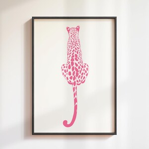 Trendy Pink Leopard Wall Art Print featuring a bold pink leopard on soft tones, perfect for girls rooms, preppy dorm decor, dopamine interiors, or jungle-inspired bedrooms. This funky animal print adds a stylish and vibrant touch to your apartment or teen room decor. Ideal for fans of maximalist wall art, aesthetic animal posters, or unique pink bedroom art. A standout piece that blends fashion vibes with wild, bold energy.