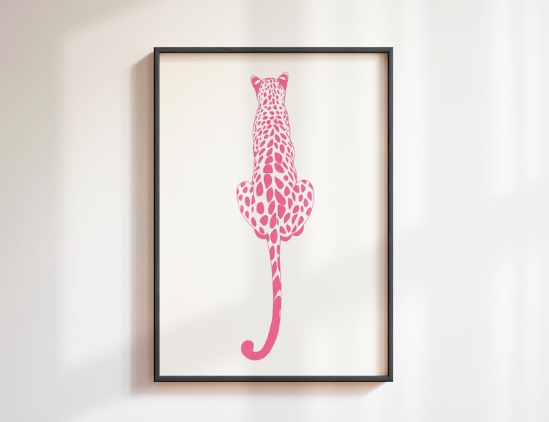 Trendy Pink Leopard Wall Art Print featuring a bold pink leopard on soft tones, perfect for girls rooms, preppy dorm decor, dopamine interiors, or jungle-inspired bedrooms. This funky animal print adds a stylish and vibrant touch to your apartment or teen room decor. Ideal for fans of maximalist wall art, aesthetic animal posters, or unique pink bedroom art. A standout piece that blends fashion vibes with wild, bold energy.