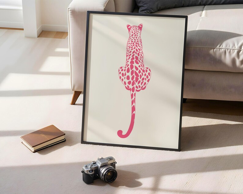 Trendy Pink Leopard Wall Art Print featuring a bold pink leopard on soft tones, perfect for girls rooms, preppy dorm decor, dopamine interiors, or jungle-inspired bedrooms. This funky animal print adds a stylish and vibrant touch to your apartment or teen room decor. Ideal for fans of maximalist wall art, aesthetic animal posters, or unique pink bedroom art. A standout piece that blends fashion vibes with wild, bold energy.