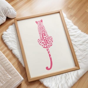 Trendy Pink Leopard Wall Art Print featuring a bold pink leopard on soft tones, perfect for girls rooms, preppy dorm decor, dopamine interiors, or jungle-inspired bedrooms. This funky animal print adds a stylish and vibrant touch to your apartment or teen room decor. Ideal for fans of maximalist wall art, aesthetic animal posters, or unique pink bedroom art. A standout piece that blends fashion vibes with wild, bold energy.