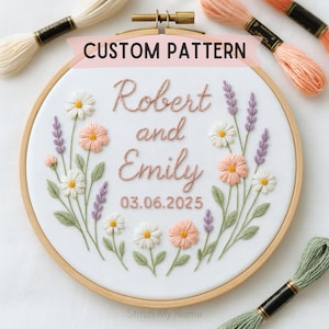 May include: Embroidered hoop art with the text "Robert and Emily" and the date 03.06.2025, surrounded by floral embroidery in peach, white, and purple. The words "Custom Pattern" are at the top. Embroidery floss in various colors is visible.