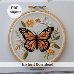 May include: A PDF template for embroidery featuring a monarch butterfly with orange and black wings surrounded by yellow and white flowers and green leaves. The design is in a wooden embroidery hoop.