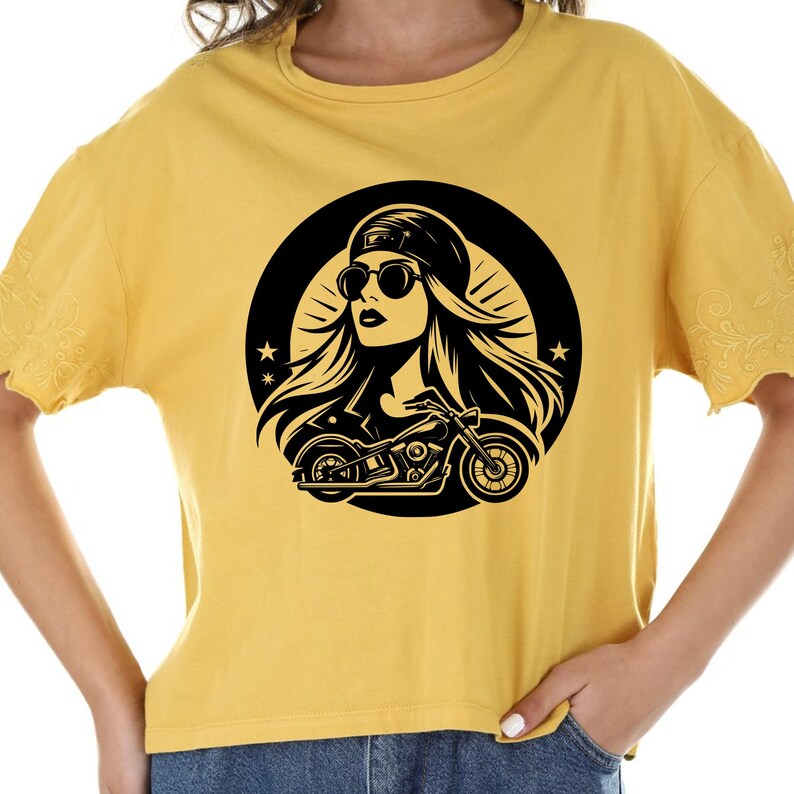 May include: A yellow t-shirt with a black and white graphic of a woman wearing sunglasses and a cap riding a motorcycle. The graphic is inside a circle with stars.