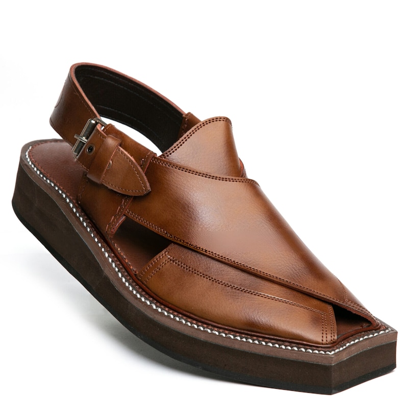May include: Brown leather sandals with a buckle strap and a thick platform sole.