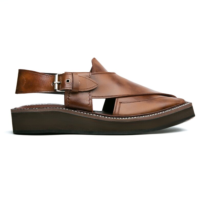 May include: Brown leather sandals with a buckle strap and a thick platform sole.