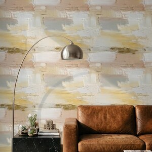 May include: Wallpaper featuring a horizontal brushstroke pattern in shades of yellow, white, grey, and beige. The design mimics thick, textured paint application with visible layering and blended colours across the entire surface of the wall covering.