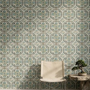 May include: A light-colored folding chair with a metal frame sits in front of a wall covered in patterned wallpaper featuring repeating circular motifs in shades of soft blue, sage green, and cream. A small bonsai tree sits on a stone table.