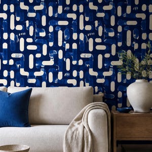 May include: Wallpaper featuring a repeating pattern of dark blue and off-white rounded rectangular shapes. The design consists of interconnected, pill-shaped forms with a hand-painted texture, creating a dense, geometric layout across the surface.