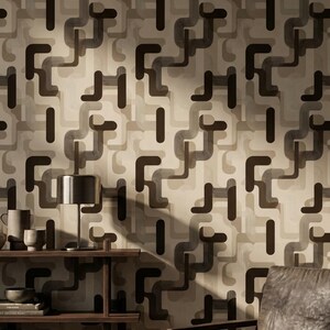 May include: A mid-century modern interior featuring a repeating geometric wallpaper pattern in shades of brown and beige. A wooden shelf displays a lamp, mugs, and books. A leather armchair sits in the corner, complementing the warm tones of the room.