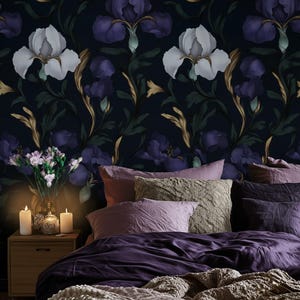 May include: A white ceramic mug with a black handle and the text "But First, Coffee" in a bold, black font. The mug is set against a blurred background, suggesting a cozy setting.