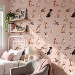 May include: A bedroom with a pink wall covered in watercolor illustrations of dogs and cats. The room includes a white bed, a gray armchair with a pink blanket, and a small side table with a lamp.