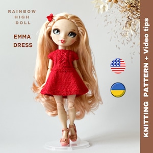 May include: A red knitted dress for a Rainbow High doll. The dress has a heart-shaped design on the front and is worn by a doll with blonde hair. The image includes the text "RAINBOW HIGH DOLL" and "EMMA DRESS".