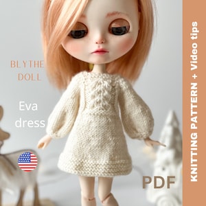 May include: Knitting pattern PDF for a white knitted dress for a Blythe doll. The pattern includes video tips. The dress has a cable knit design on the bodice and puffed sleeves.