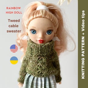 May include: A doll wearing a green tweed cable knit sweater with a turtleneck. The doll has blonde hair and blue eyes. The doll is wearing a plaid skirt. The image also includes the text "Rainbow High Doll" and "Tweed cable sweater".