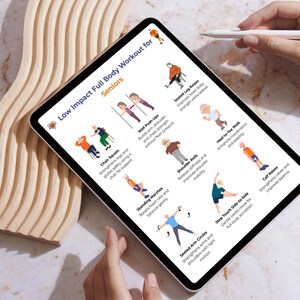 May include: A tablet displays a workout routine for seniors, titled "Low Impact Full Body Workout for Seniors." The screen shows illustrated exercises like chair squats, wall push-ups, and seated leg raises. A hand holds a stylus near the screen.