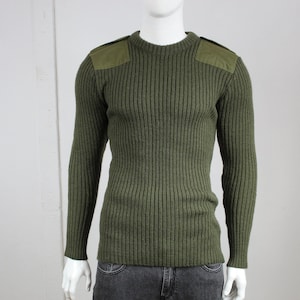 May include: A green ribbed knit sweater with two green fabric patches on the shoulders.
