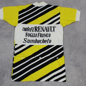 May include: A yellow and black striped cycling jersey with white accents. The back of the jersey has the text "autoff.RENAULT FOGLIA FRANCO SAMBUCHETO" printed in black.