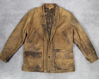 May include: A brown leather jacket with a snap closure and two large pockets on the front. The jacket has a worn, vintage look.