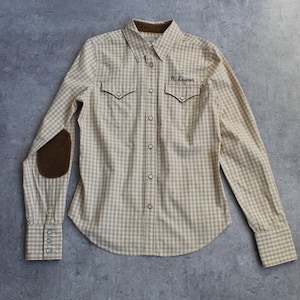 May include: A beige and white checked shirt with long sleeves, a brown corduroy collar, and brown elbow patches. The shirt features two front pockets and embroidered text "R. Lauren" on the chest.