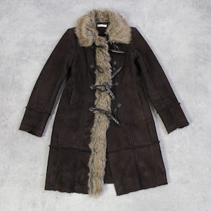 May include: A dark brown coat with a faux fur collar and trim. The coat features toggle closures and long sleeves. The coat is a long length and appears to be made of suede or a similar material.