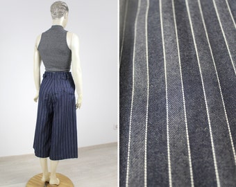 May include: Wide-leg, cropped pants with a high waist and a blue and white striped pattern.