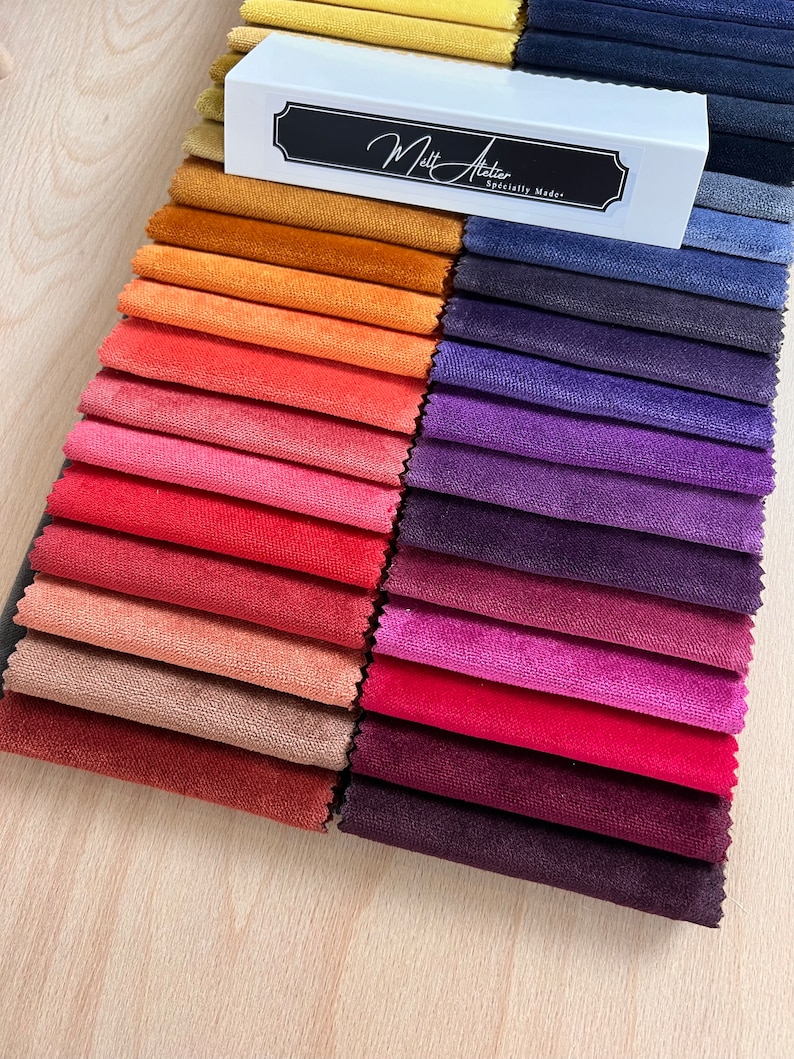 May include: A collection of fabric swatches in various shades of red, orange, purple, and blue. The swatches are arranged in rows and are labeled "Matt Adler, Specially Made."