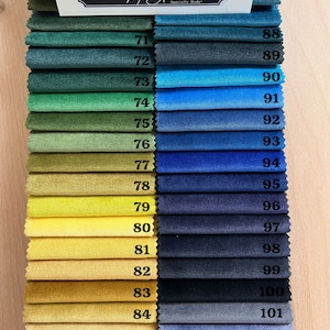 May include: A swatch card with 17 fabric samples, numbered 71 to 87 on the left and 88 to 104 on the right. The fabric samples range in color from dark green to orange. The card is labeled "Melt Atelier, Specially Made."