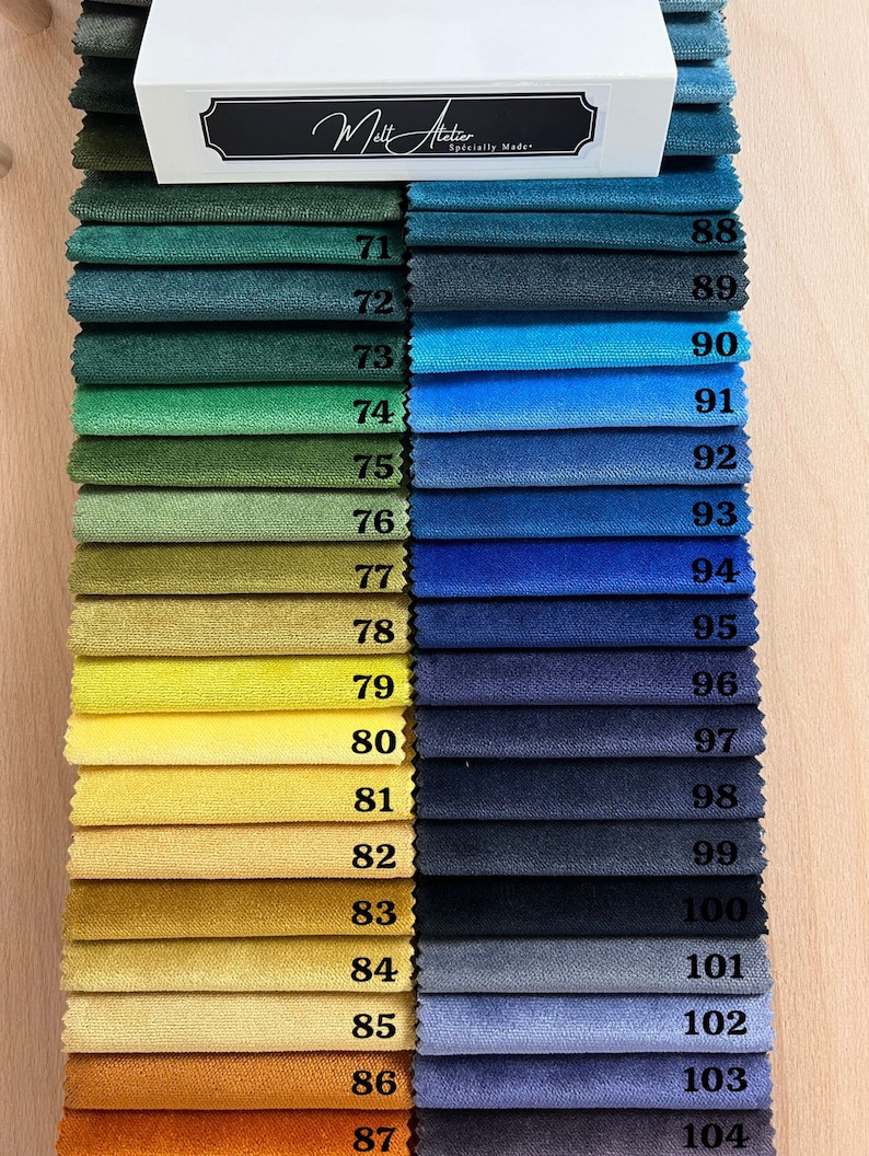 May include: A swatch card with 17 fabric samples, numbered 71 to 87 on the left and 88 to 104 on the right. The fabric samples range in color from dark green to orange. The card is labeled "Melt Atelier, Specially Made."