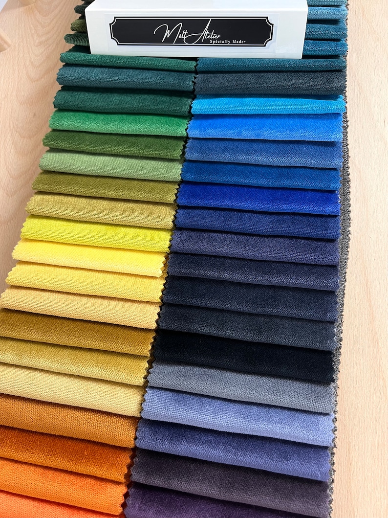 May include: A fabric swatch book with a variety of colors, including green, blue, yellow, orange, and brown. The book is labeled "Matt Atelier, Specially Made."