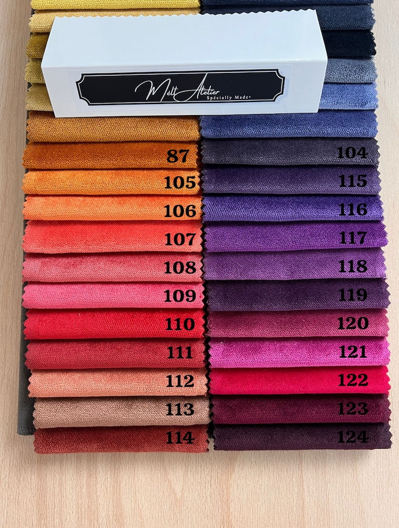 May include: A swatch card with 17 fabric samples in various shades of orange, red, pink, purple, and blue. The swatches are numbered 87 to 114 and 104 to 124. The card is labeled "Melt Atelier, Specially Made."